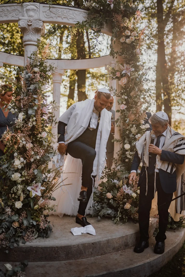Jewish groom stepping plates and breaking them as a jewish wedding tradition