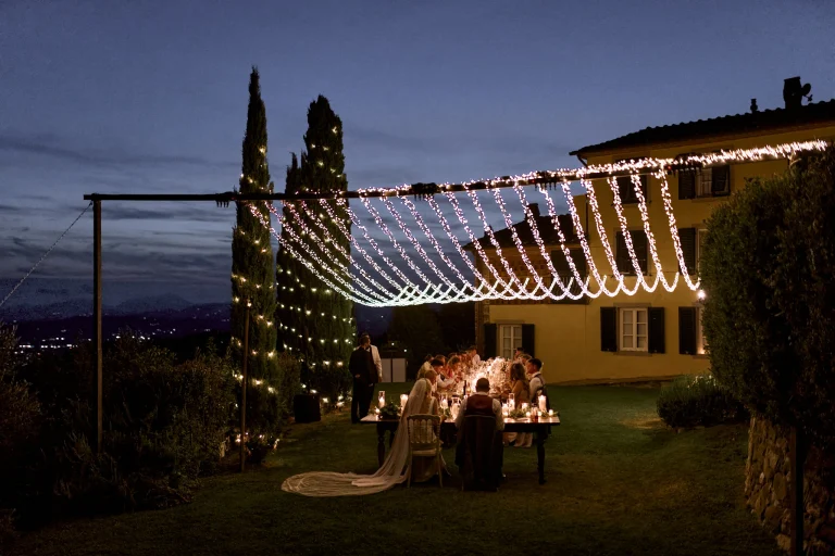 A beautiful wedding dinner reception with fairy light in Tuscany